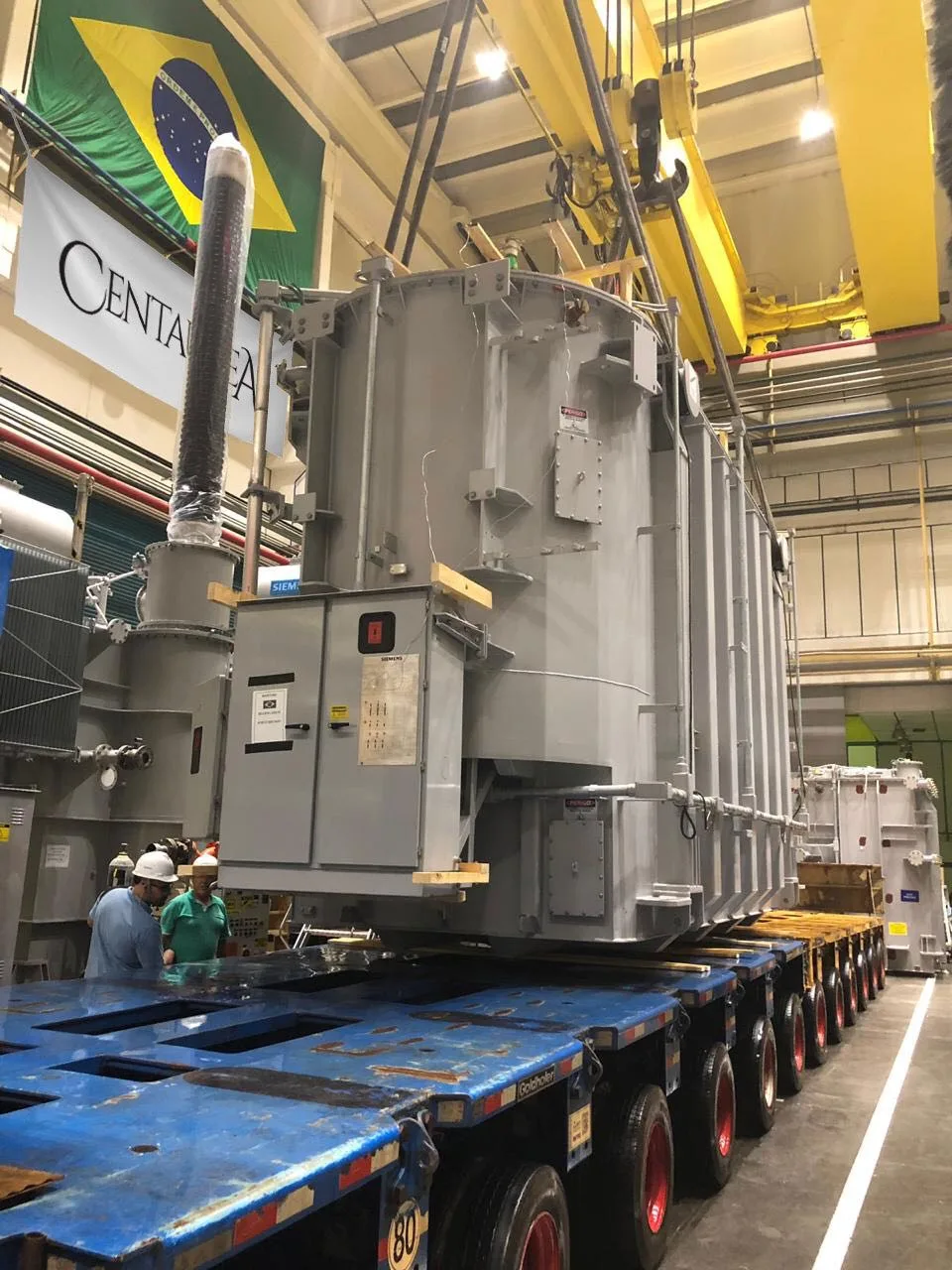 Power transformer positioned on a hydraulic multi-axle trailer inside a manufacturing plant in Brazil